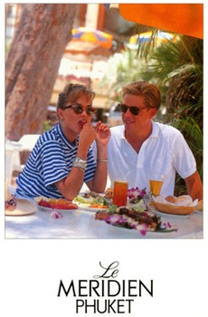 Couple dining outdoors at Le Meridien Phuket, sharing a smile over plates and colorful drinks.